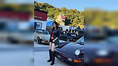 Moon Ga-young poses next to a supercar at a Porsche event... her slender legs catch the eye
